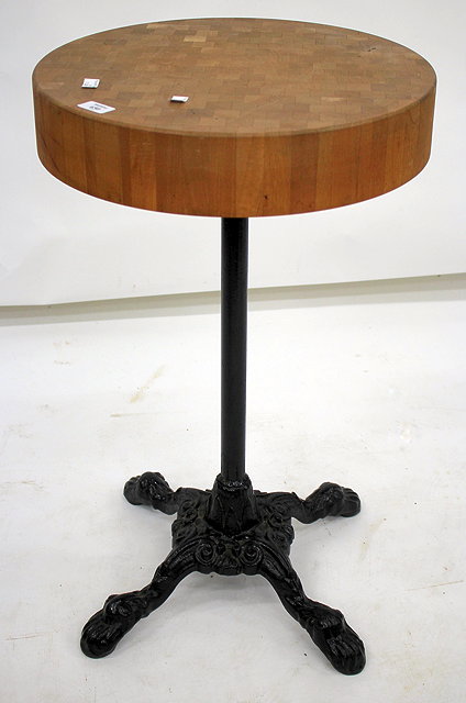 Appraisal: A CIRCULAR BUTCHERS BLOCK SIDE TABLE with black painted cast