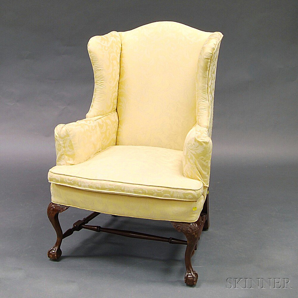 Appraisal: Chippendale-style Upholstered Carved Mahogany Wing Chair the arched cresting and