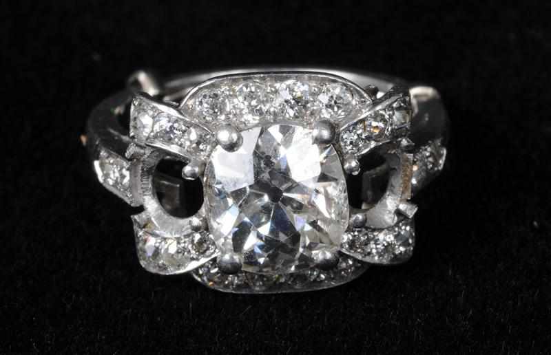 Appraisal: PLATINUM AND DIAMOND RING Centering one cushion-shaped diamond approx cts