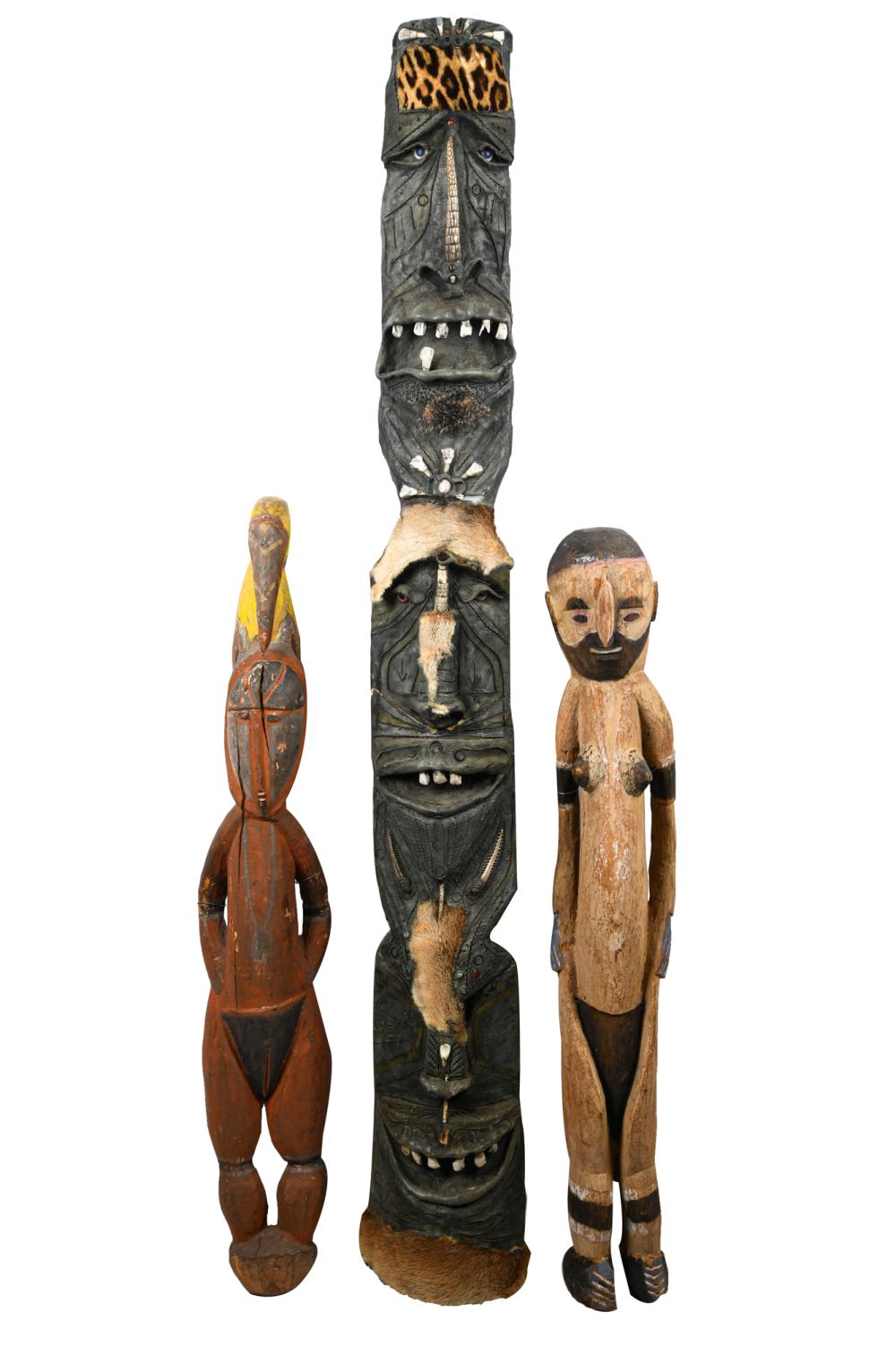 Appraisal: THREE PAPAU NEW GUINEA-STYLE CARVINGSthe large totem inches high Condition