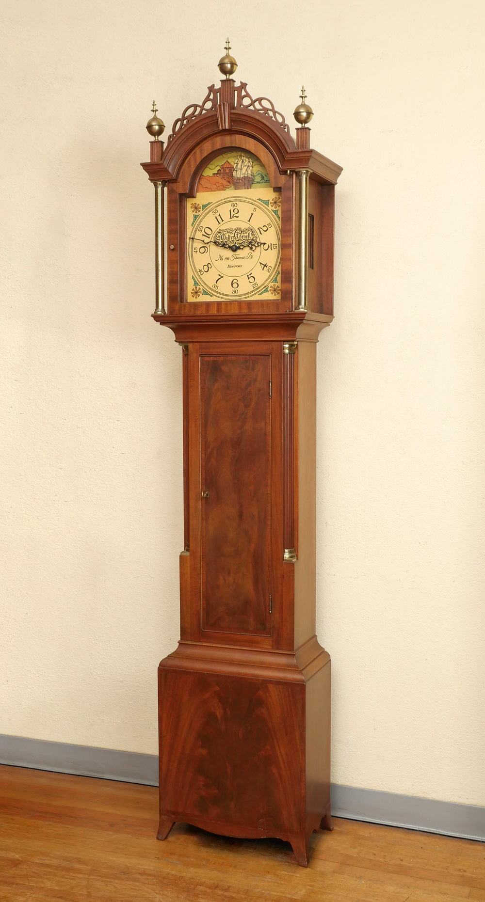 Appraisal: WALTER CORNELL GRANDFATHER CLOCK Surmounted by metal finials and pierced