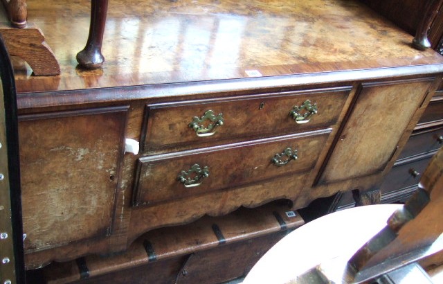 Appraisal: A th century walnut sideboard with a pair of central