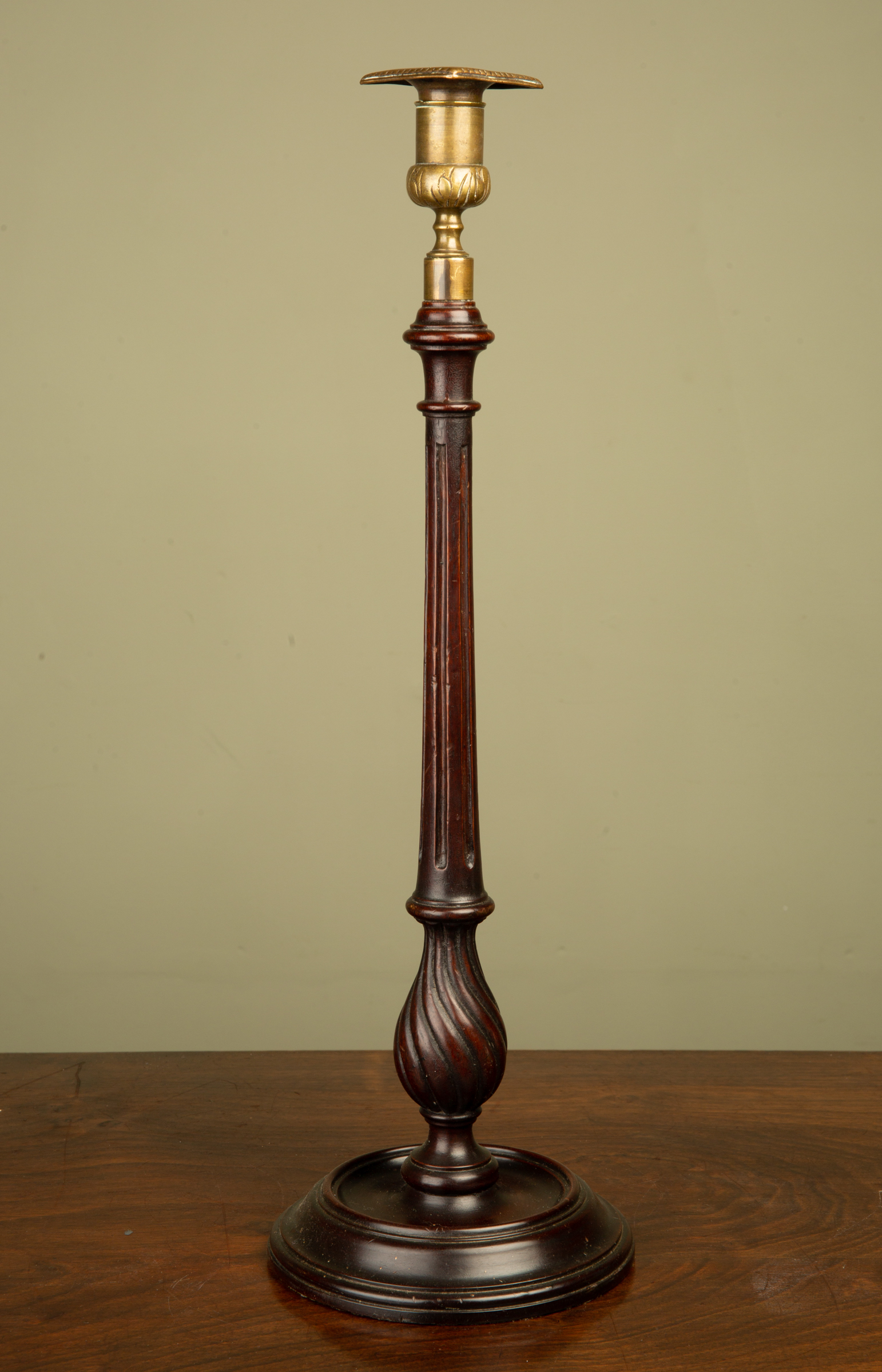 Appraisal: An early th century mahogany and brass candle stick with