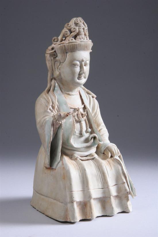 Appraisal: CHINESE BISCUIT AND QINGBAI PORCELAIN FIGURE OF GUANYIN Yuan Dynasty