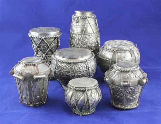 Appraisal: Seven Indian white metal pots modelled as bongo drums of