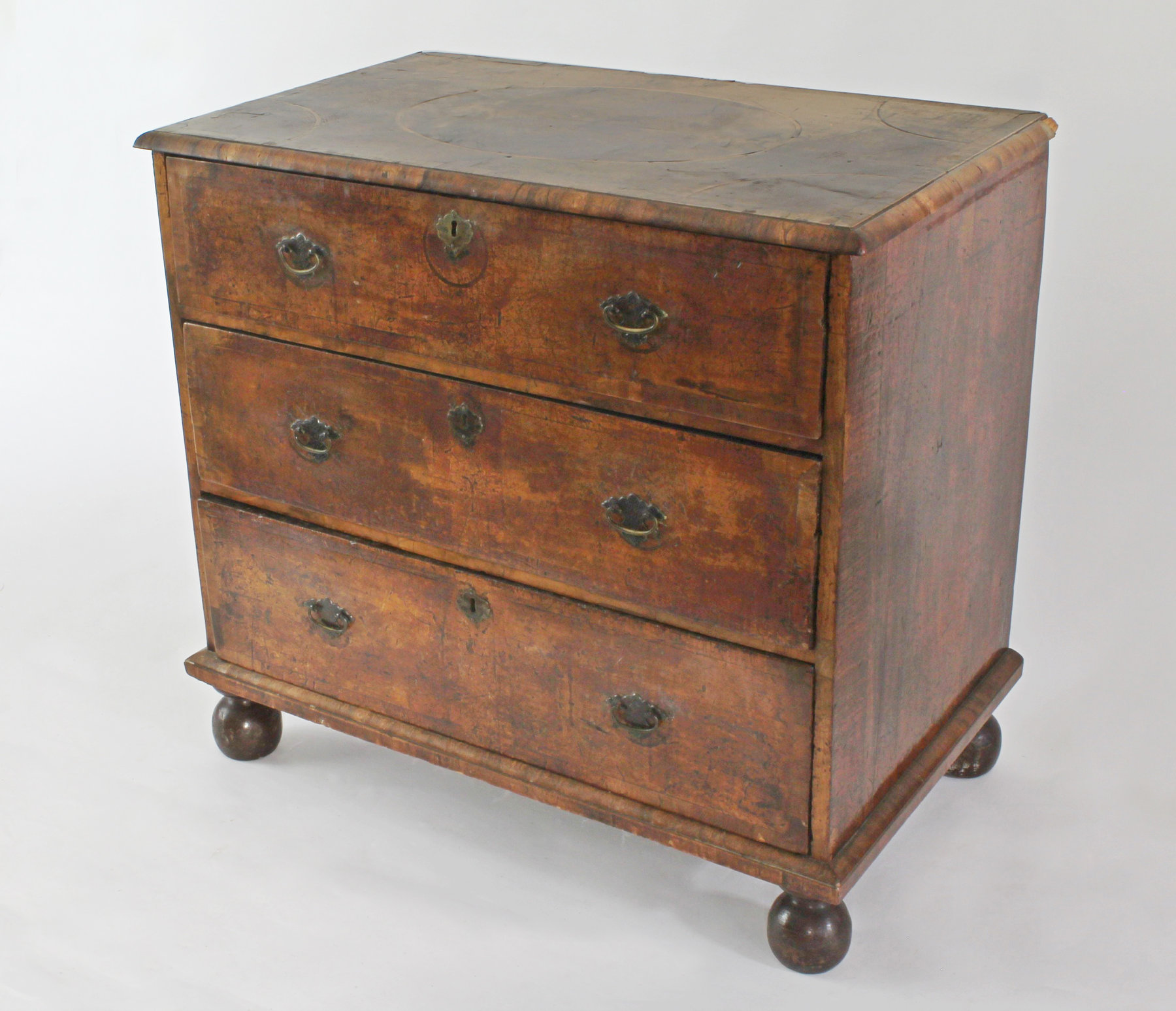 Appraisal: An th Century walnut chest with geometric top and cross