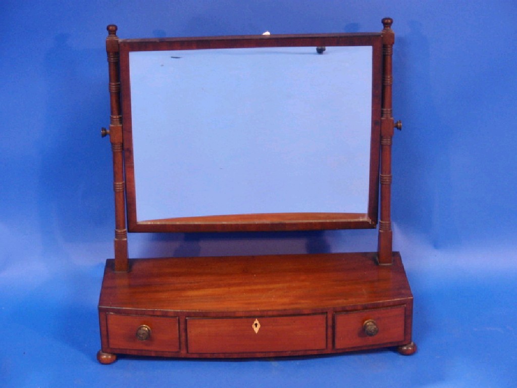 Appraisal: A Regency mahogany bow front dressing table mirror with rectangular