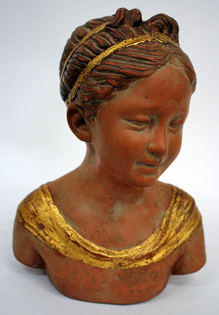 Appraisal: A TERRACOTTA AND GILT HIGHLIGHTED BUST OF A GIRL stamped