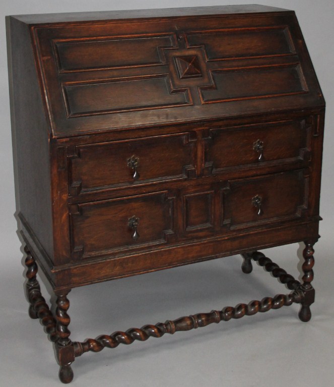 Appraisal: An early thC panelled oak bureau the fall front enclosing