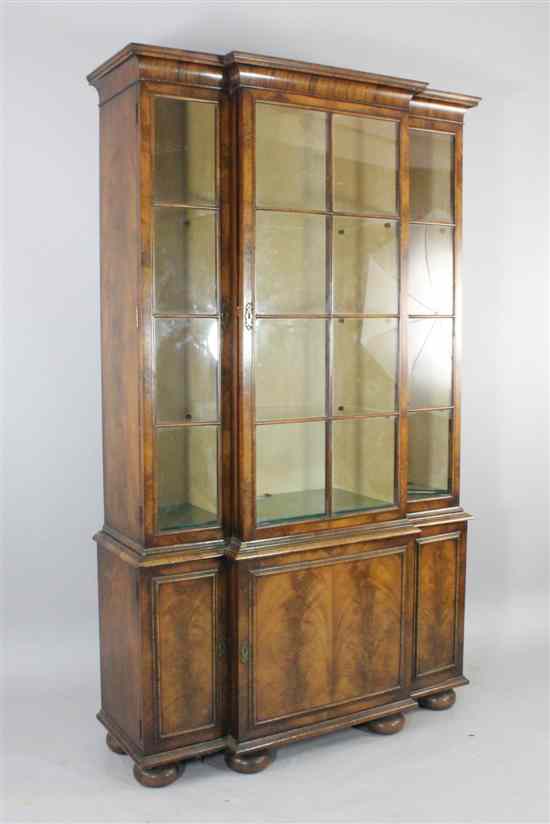 Appraisal: A 's walnut breakfront display cabinet with three bar glazed