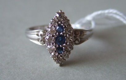 Appraisal: A sapphire and diamond set marquise shaped cluster ring mounted