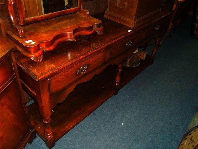 Appraisal: A Georgian style oak dresser base with three drawers on