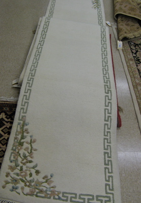 Appraisal: TWO MATCHING INDO-CHINESE RUNNER both with plain ivory fields with