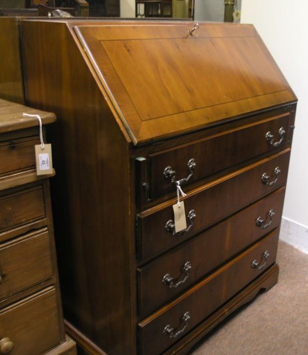 Appraisal: A reproduction yew veneered bureau fall front enclosing fittings above