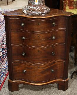 Appraisal: George III mahogany corner cabinet circa having a serpentine top