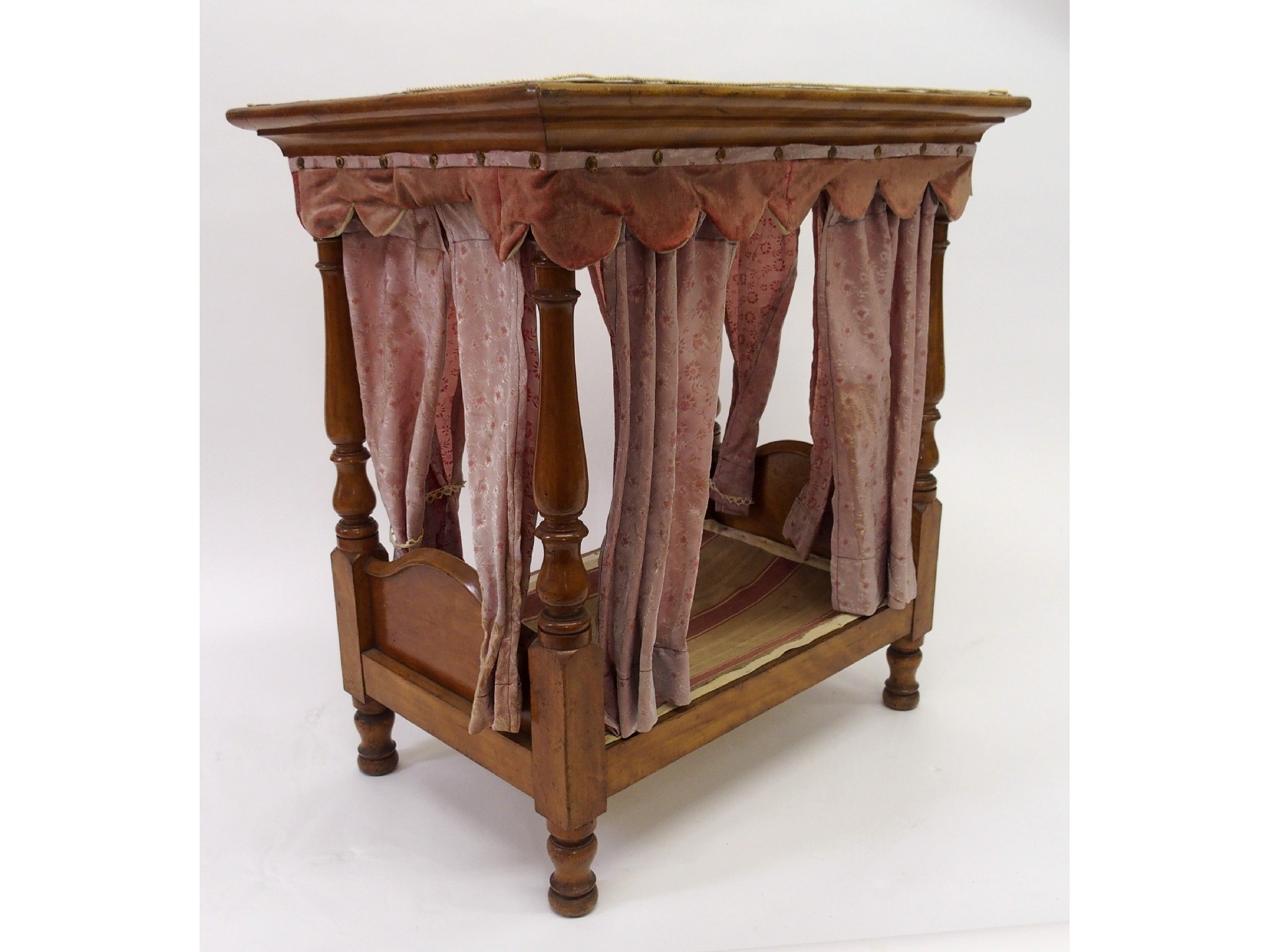 Appraisal: A mid-Victorian mahogany doll's four poster bedwith shaped velvet canopy