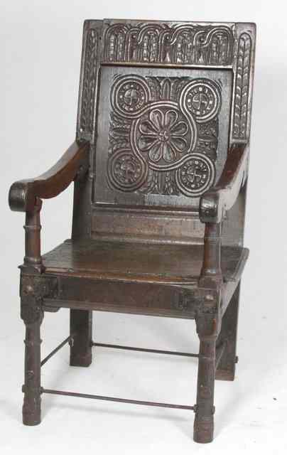 Appraisal: A th Century oak carved panel back armchair circa on