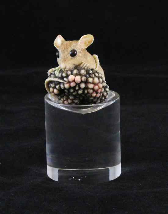 Appraisal: A contemporary resin okimono of a mouse clambering over blackberries