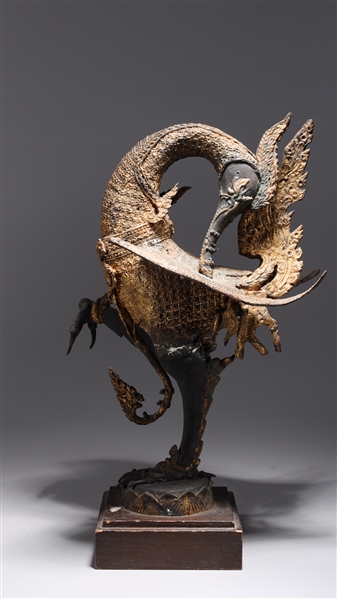 Appraisal: Large Burmese metal bird with partial gilt on wood stand