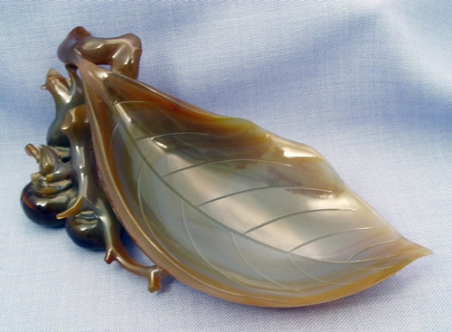 Appraisal: CHINESE CARVED JADE LEAF Smooth as glass with squirrel and