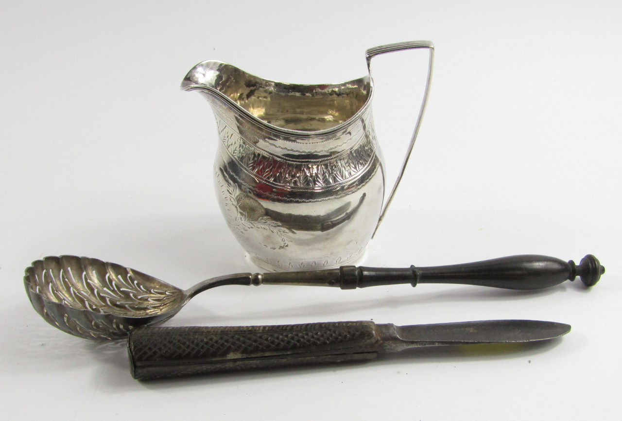 Appraisal: A Georgian thC silver cream jug with engraved foliate decoration