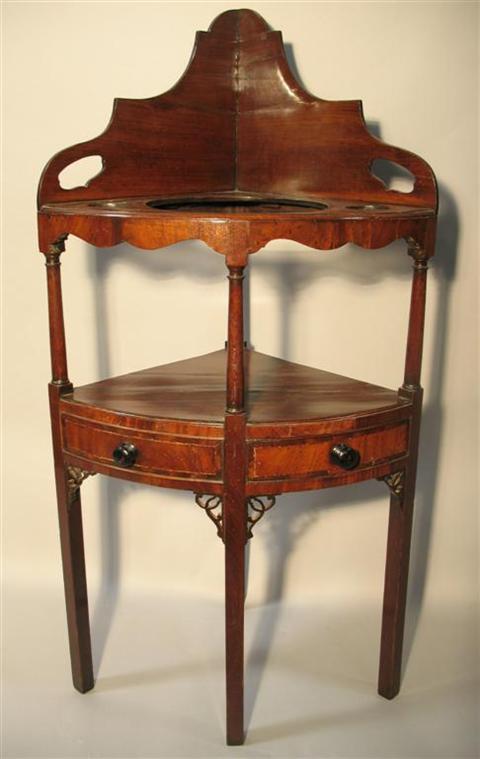 Appraisal: GEORGE III STYLE MAHOGANY CORNER WASHSTAND the shaped backsplash with