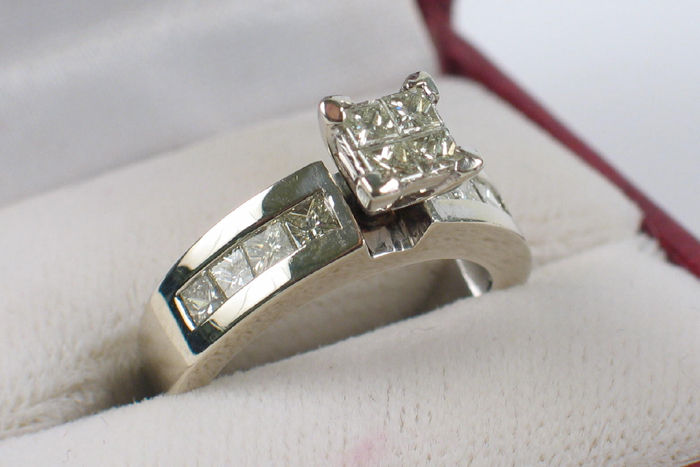 Appraisal: DIAMOND AND FOURTEEN KARAT WHITE GOLD RING Four princess-cut diamonds