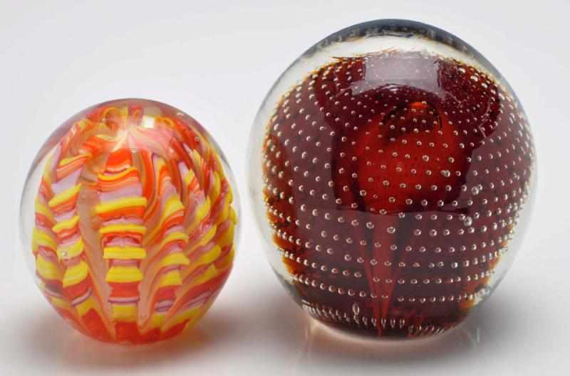 Appraisal: Lot of Paperweights Description The smaller paperweight is a lobed-style