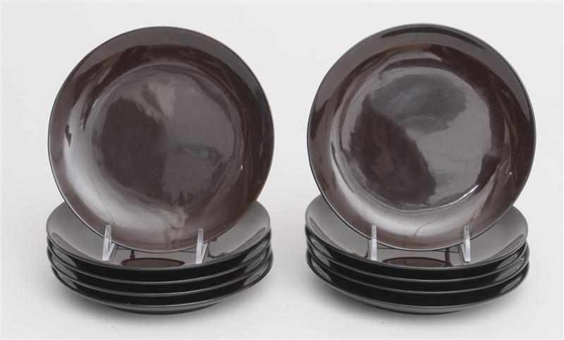 Appraisal: EILEEN GRAY - SET OF TEN BROWN LACQUER FOOTED PLATES