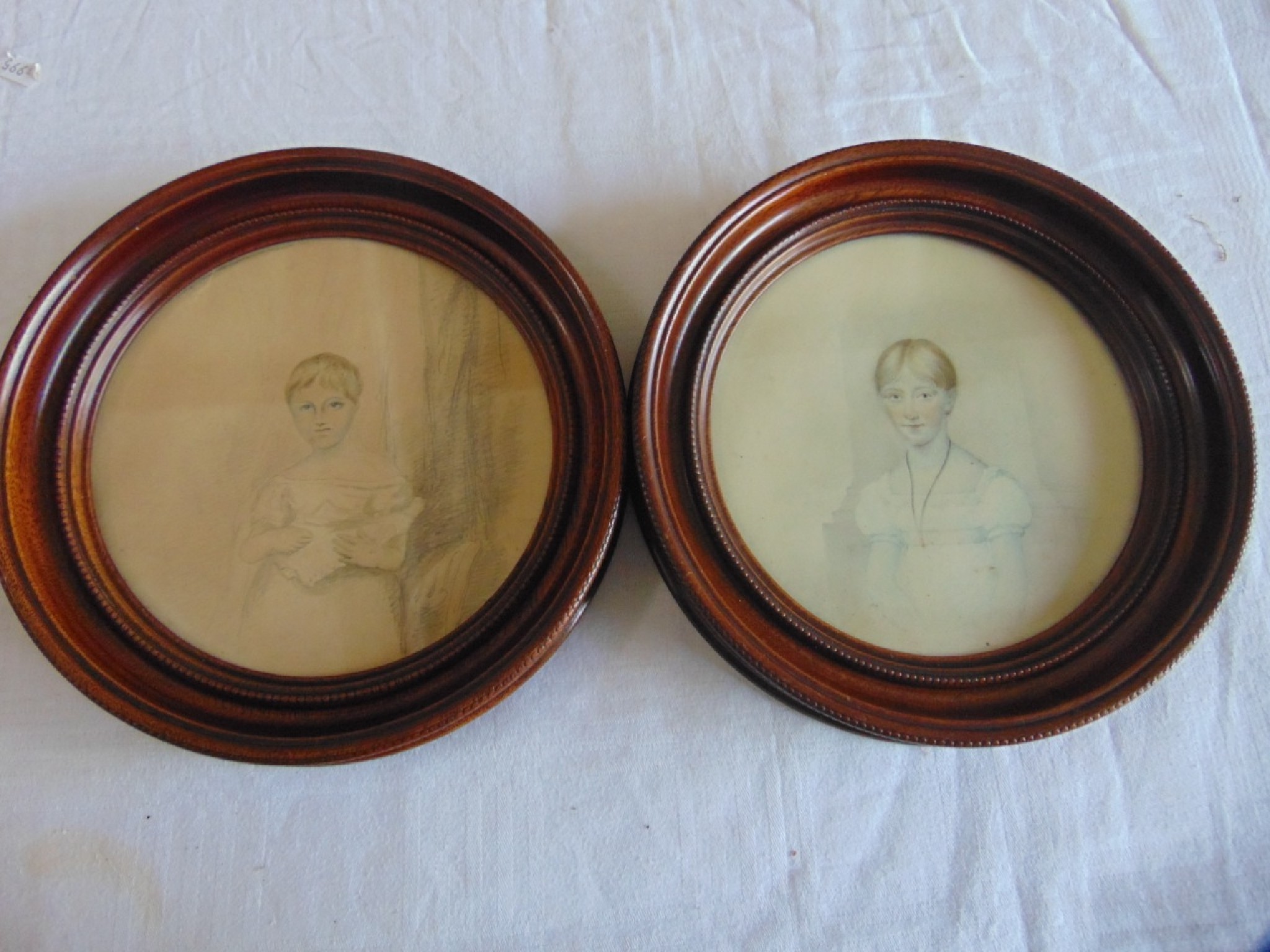 Appraisal: A pair of early th century watercolour portraits of oval