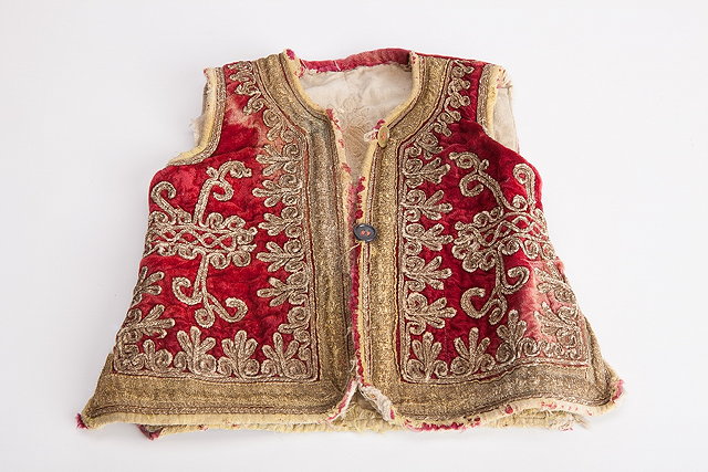 Appraisal: AN AFGHAN CHILD'S WAISTCOAT with embroidered decoration on a dark