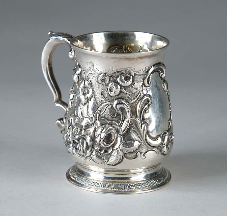 Appraisal: SILVER HANDLED MUG Beautiful reposse floral design encircles this beautiful