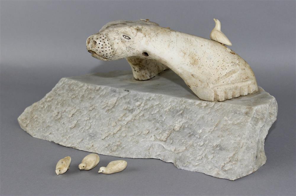 Appraisal: INUIT WHALE BONE SCULPTURE of stylized seal wtih sea birds