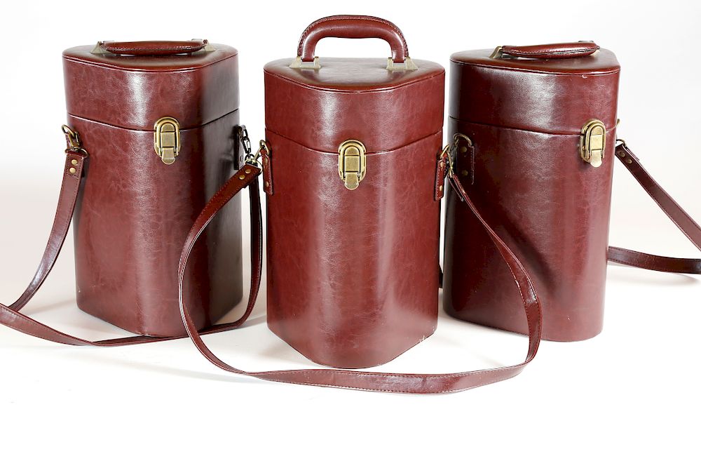 Appraisal: Three Burgundy Leatherette Three-Bottle Wine Carriers Exclusive on Bidsquare Three