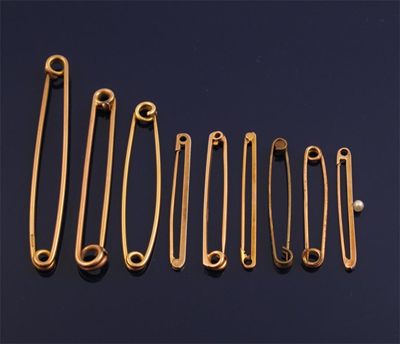 Appraisal: Eight assorted gold stock pins and bar brooches and a