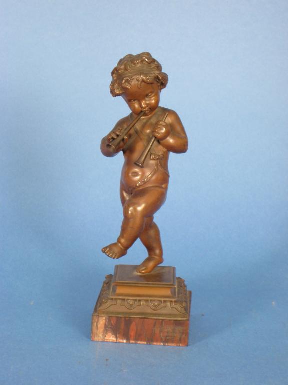 Appraisal: A bronze Figure of a Cherub blowing a horn on