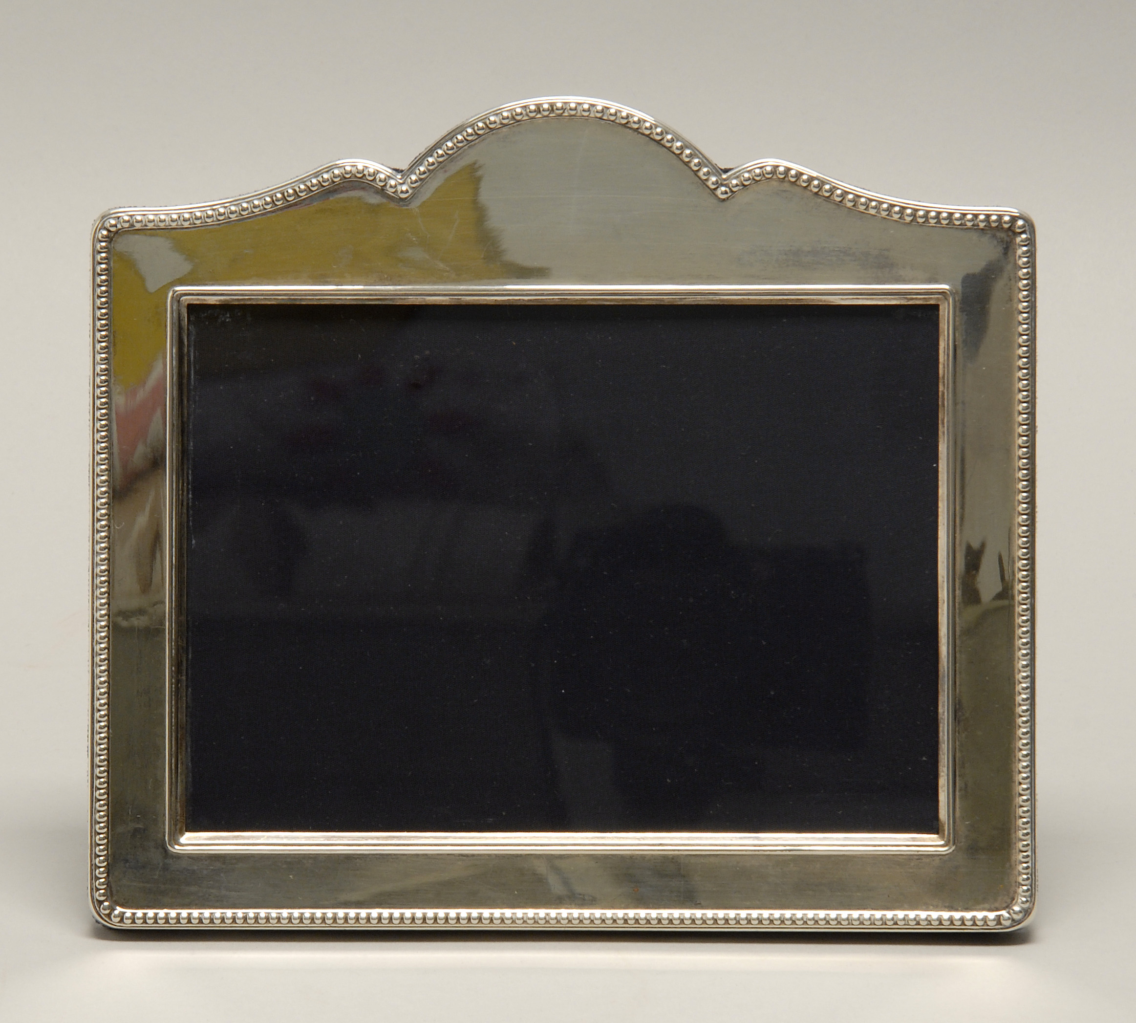 Appraisal: ELIZABETH II STERLING SILVER-MOUNTED PHOTOGRAPH FRAME Sheffield John Bull Ltd