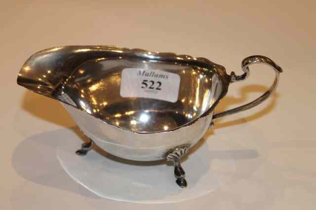 Appraisal: A SILVER GEORGIAN STYLE SAUCE BOAT with loop handle shaped