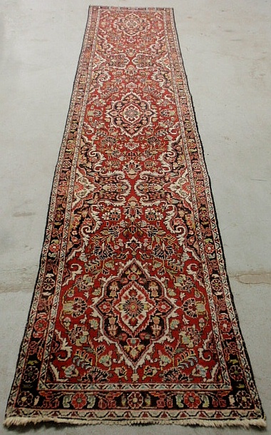 Appraisal: - Hamadan oriental hall runner with a red field and