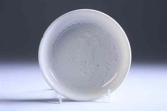 Appraisal: CHINESE WHITE GLAZED PORCELAIN DRAGON DISH Qing Dynasty The interior