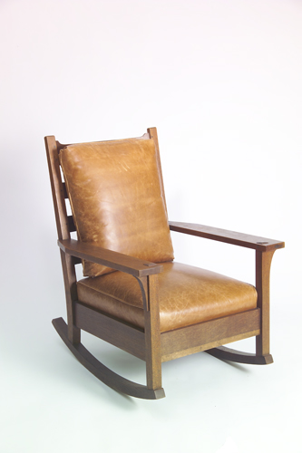 Appraisal: GUSTAV STICKLEY Large open-arm rocker with shaped crest rail drop-in