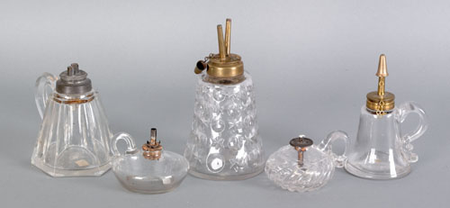 Appraisal: Five blown and pressed colorless glass finger lamps th c