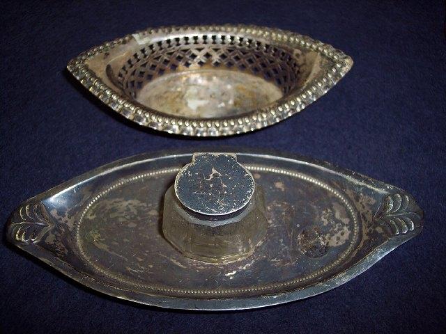 Appraisal: An oval inkstand raised on four ball feet and fitted