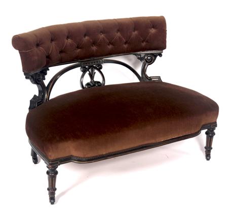 Appraisal: A Victorian Aesthetic two seat settee the scroll button back