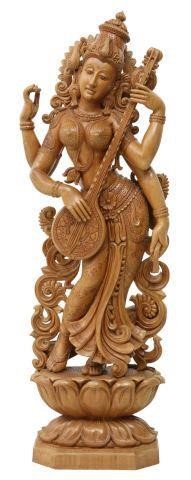 Appraisal: Carved wood sculpture India Saraswati playing a veena accompanied by