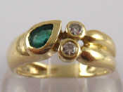 Appraisal: A yellow metal tests carat gold emerald and diamond ring