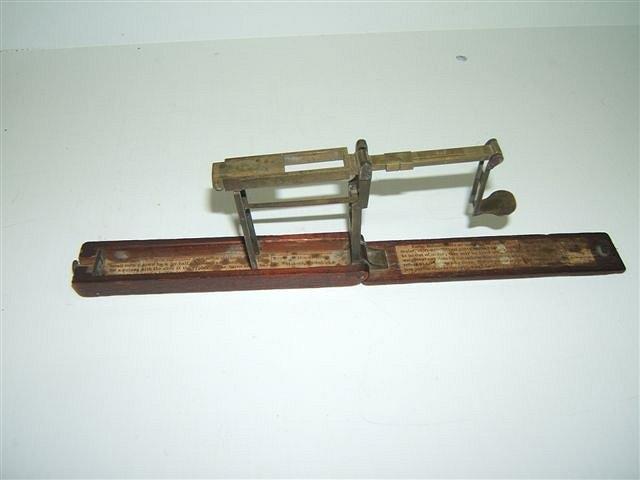 Appraisal: A GEORGE III MAHOGANY AND BRASS GUINEA SCALE with label