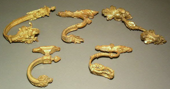 Appraisal: Five gilt metal tiebacks various sizes and shapes