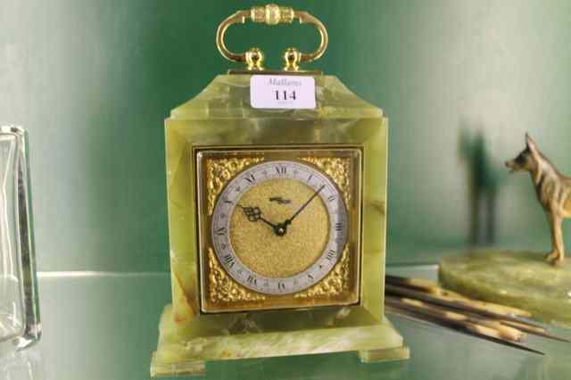 Appraisal: A GREEN ONYX MANTEL CLOCK with Swiss movement retailed by