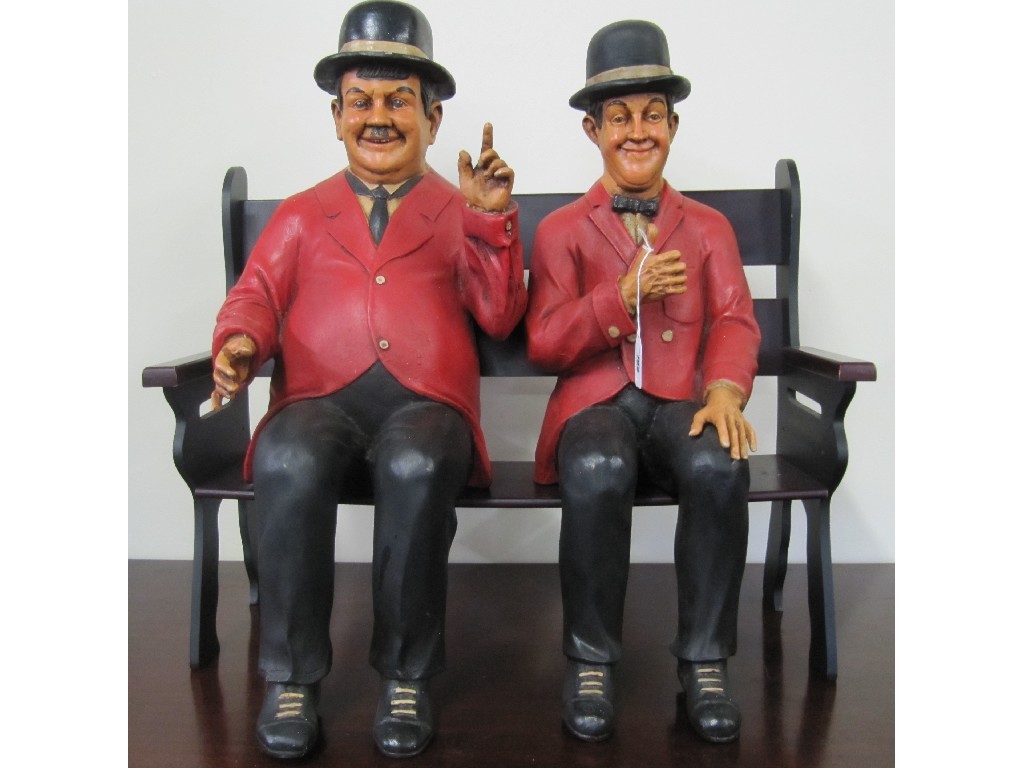 Appraisal: Pair of Laurel and Hardy figures sitting on a bench